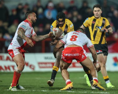 Jeremiah Simbiken of Castleford Tigers is tackled by Elliot Minchella of Hull KR and Sauaso Sue of Hull KR during Betfred Super League Round 1 match Hull KR vs Castleford Tigers at Sewell Group Craven Park, Kingston upon Hull, UK, 14th February 2025 clipart