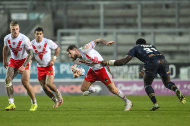 St. Helens 'ten Daryl Clark, 15 Şubat 2025' te St Helens-Salford Red Devils maçında Salford Red Devils 'den Bardyel Wells' i geçti.