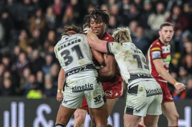 Junior Nsemba of Wigan Warriors is tackled by , Brad Fash during the Betfred Super League Round 2 match Hull FC vs Wigan Warriors at MKM Stadium, Hull, United Kingdom, 21st February 2025 clipart