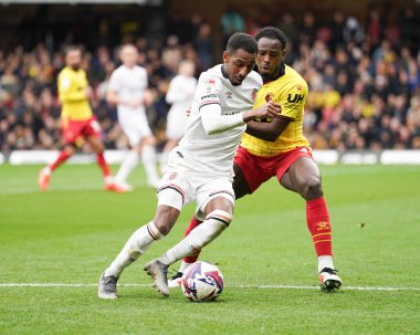 Isaiah Jones of Luton Town holding Kvin Keben of Watford off with the ball during the Sky Bet Championship match Watford vs Luton Town at Vicarage Road, Watford, United Kingdom, 23rd February 2025 clipart