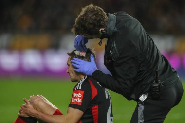 Timothy Castagne of Fulham receives treatment for a head injury during the Premier League match Wolverhampton Wanderers vs Fulham at Molineux, Wolverhampton, United Kingdom, 25th February 2025 clipart