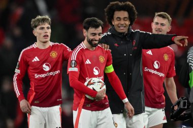 Manchester United takımından Bruno Fernandes, UEFA Avrupa Ligi son 16 maçında Manchester United - Real Sociedad maçında Old Trafford, Manchester, İngiltere, 13 Mart 2025 'te hat-trick yaptıktan sonra maç topunu topluyor.