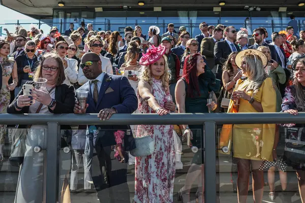 Yarışçılar, 5 Nisan 2025 tarihinde İngiltere 'nin Liverpool kentindeki Aintree Yarış Pisti' nde düzenlenen Randox Grand National 2025 Ulusal Günü 'ne bakıyorlar.