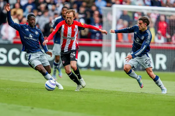 Brentford 'dan Mikkel Damsgaard, Premier League karşılaşmasında Manchester United' dan Kobbie Mainoo ve Manuel Ugarte 'nin baskısı altında. Brentford Manchester United' a karşı Gtech Community Stadyumu, Londra, 4 Mayıs 2025