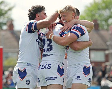 Wakefield Trinity 'den Josh Rourke, Wakefield Trinity' den Seth Nikotemo ve Wakefield Trinity 'den Jayden Myers ile birlikte, Wakefield Süper Ligi karşılaşmasında, Wakefield Trinity, Wakefield, Wakefield, United Kitchens Stadyumu' nda Salford Red Devils 'e karşı oynadığı maçı kutluyor.