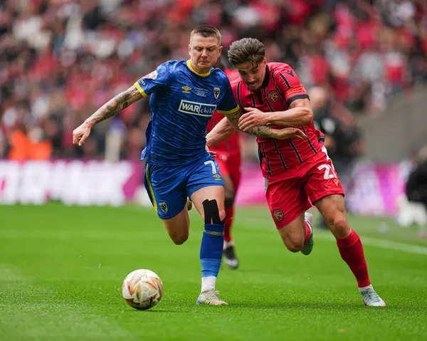 AFC Wimbledon 'dan James Tilley ve Walsall takımından Jamie Jellis, 26 Mayıs 2025' te Wembley Stadyumu 'nda oynanan Wimbledon-Walsall maçında karşılaşacaklar.