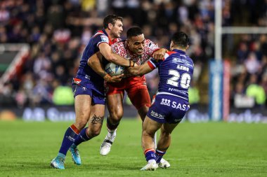 Joe Ofahengaue of Leigh Leapords is tackled by Jay Pitts of Wakefield Trinity and Mason Lino of Wakefield Trinity during the Betfred Super League play-off Eliminator 1 match Leigh Leopards vs Wakefield Trinity at Progress With Unity Stadium, Leigh