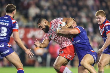 Isaac Liu of Leigh Leopards is tackled during the Betfred Super League play-off Eliminator 1 match Leigh Leopards vs Wakefield Trinity at Progress With Unity Stadium, Leigh, United Kingdom, 26th September 2025