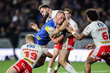 Tom Holroyd of Leeds Rhinos is tackled by George Delaney of St. Helens and Alex Walmsley of St. Helens during Betfred Super League play-off Eliminator 1 match Leeds Rhinos vs St Helens at Headingley Stadium, Leeds, United Kingdom, 27th September  