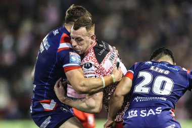Frankie Halton of Leigh Leopards is tackled by Cam Scott of Wakefield Trinity during the Betfred Super League play-off Eliminator 1 match Leigh Leopards vs Wakefield Trinity at Progress With Unity Stadium, Leigh, United Kingdom, 26th September 2025
