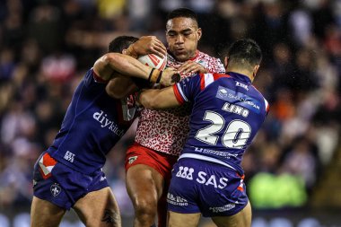 Joe Ofahengaue of Leigh Leapords is tackled by Jay Pitts of Wakefield Trinity and Mason Lino of Wakefield Trinity during the Betfred Super League play-off Eliminator 1 match Leigh Leopards vs Wakefield Trinity at Progress With Unity Stadium 