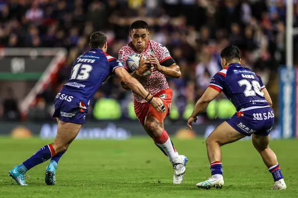 Joe Ofahengaue of Leigh Leapords is tackled by Jay Pitts of Wakefield Trinity and Mason Lino of Wakefield Trinity during the Betfred Super League play-off Eliminator 1 match Leigh Leopards vs Wakefield Trinity at Progress With Unity Stadium
