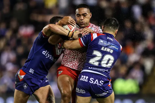 Joe Ofahengaue of Leigh Leapords is tackled by Jay Pitts of Wakefield Trinity and Mason Lino of Wakefield Trinity during the Betfred Super League play-off Eliminator 1 match Leigh Leopards vs Wakefield Trinity at Progress With Unity Stadium 
