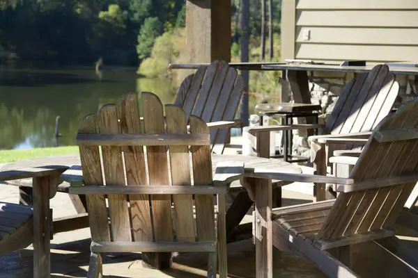 Wooden outdoor furniture on a covered patio at a lake house