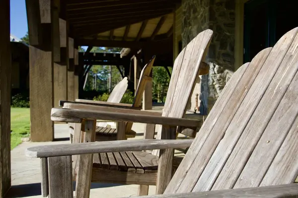 Wooden outdoor furniture on a covered patio at a lake house