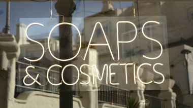 neon light with the words cosmetics and soaps