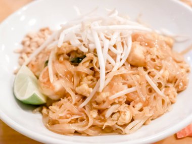 Geleneksel Tayland yemeği Tayland yemeği beyaz sığ bir kase üzerinde limonlu fasulye filizi ile servis edilir.