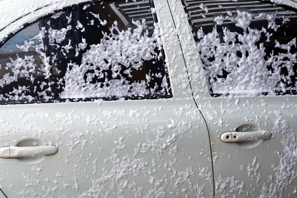 A spray foam car wash on body car to washing.