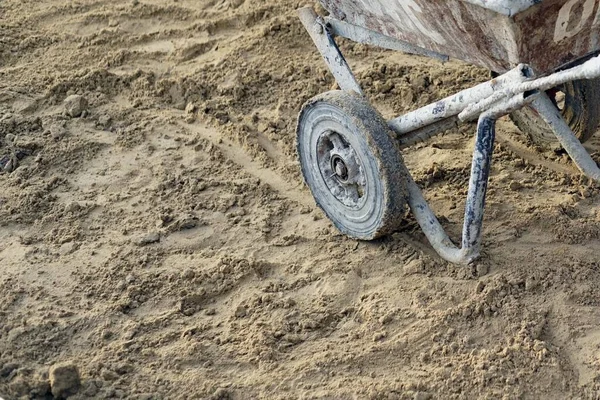 A wheelbarrow on the sand in the construction site preparing move.