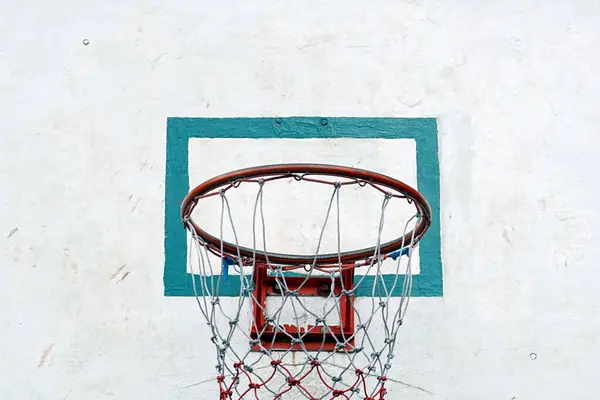 A basketball Hoop on the old white wooden panel in the basketball court