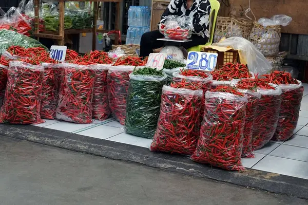 stock image A chili stall at the market with a seller backside.