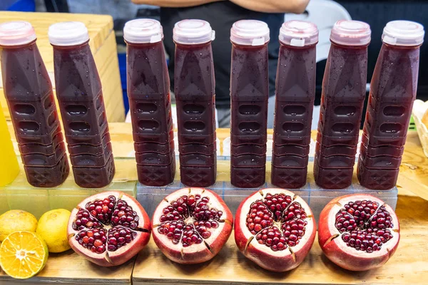 Pomegranate Fruit Halved Revealing Its Arils Seeds Jiuce Bottle One — Stock Photo, Image