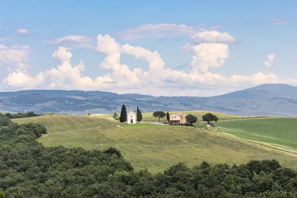 stock image The popular Vitaleta Chapel on picturesque Tuscany Italy countryside with green rolling hills against blue sky