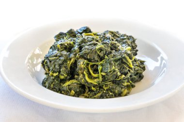 Simple and authentic healthy Italian sauteed spinach served in restaurant in Tuscany, Italy