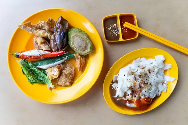 stock image Overhead view of Yong tofu with chee cheong fun combination served in plate with sauces, popular street food in Malaysia eateries