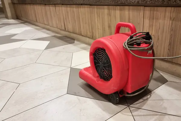 Close-up of portable floor dryer fan used in public washroom and toilet to dry the floor after washing and cleaning, keeping public space hygienic