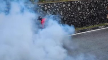 Çalılıkların etrafındaki böcek ilaçlarını buğulandıran ve sivrisinek larvalarını öldürmek için kurutan kişi dang, zika ve sıtma gibi sivrisinek kaynaklı hastalıkları önlüyor.