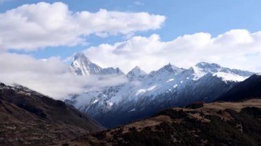 Sichuan Çin 'de hareket eden bulutlarla Siguniang Dağı' nın panoramik manzarası. Yaomei feng 'in en yüksek olduğu dört tepe.