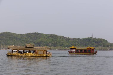 Çin 'in Hangzhou kentindeki Batı Gölü' nde seyir hizmetleri sunulmaktadır..