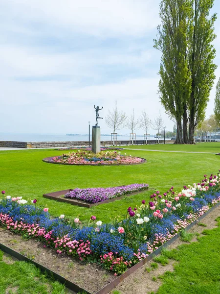 stock image Rorschach, Switzerland, is a small town situated directly at the coast of Lake Constance. Beautiful garden with flowers and artworks.