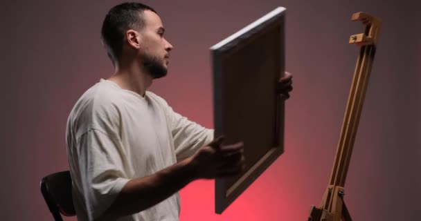Handsome Young Man Painter Placing Canvas Easel Prepearing Painting Studio — Stok video