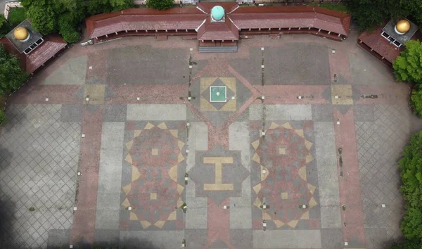 A view of the beautiful field in the middle of the city square by drone, this field is for ceremonies, sports, music concerts, special markets or other events