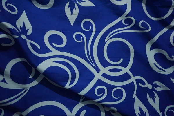 Bright blue background with batik ornament like flowers in indonesia