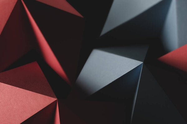 Geometric shapes made colorful paper, dark background