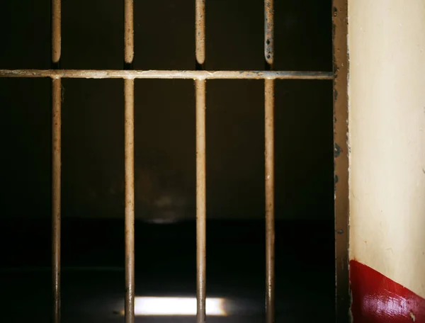 Prison door bars in prison cell closed on dark background medium selective focus