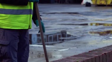 Road sweeper using a broom to sweep road medium 4k slow motion selective focus