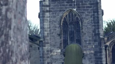 Old stone gothic church in England reveal shot 4k wide dolly selective focus