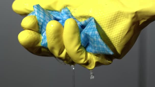 Hand Yellow Rubber Glove Squeezing Cleaning Cloth Close Slow Motion — Stockvideo