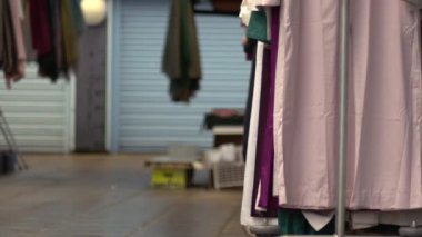 Market stall business woman at end of day wide zoom shot selective focus 