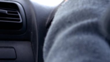 Hands on car steering wheel driving slow motion close up zoom shot selective focus
