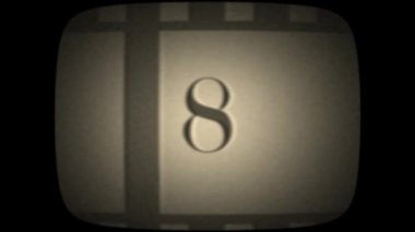 Old damaged leader film countdown with noise and scratches on retro television 