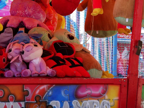 Fairground stall with toys and stuffed animals medium shot selective focus