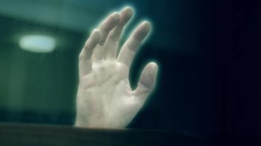 Creepy ghost hand at window close up slow motion zoom selective focus
