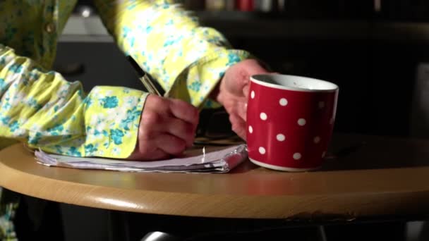 Woman Hot Drink Writing Notepad Kitchen Table Medium Zoom Shot — Stockvideo