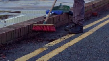 Road sweeper using a broom to sweep road medium 4k shot slow motion selective focus
