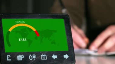 Woman makes savings with home smart meter showing electricity use 4k shot background selective focus